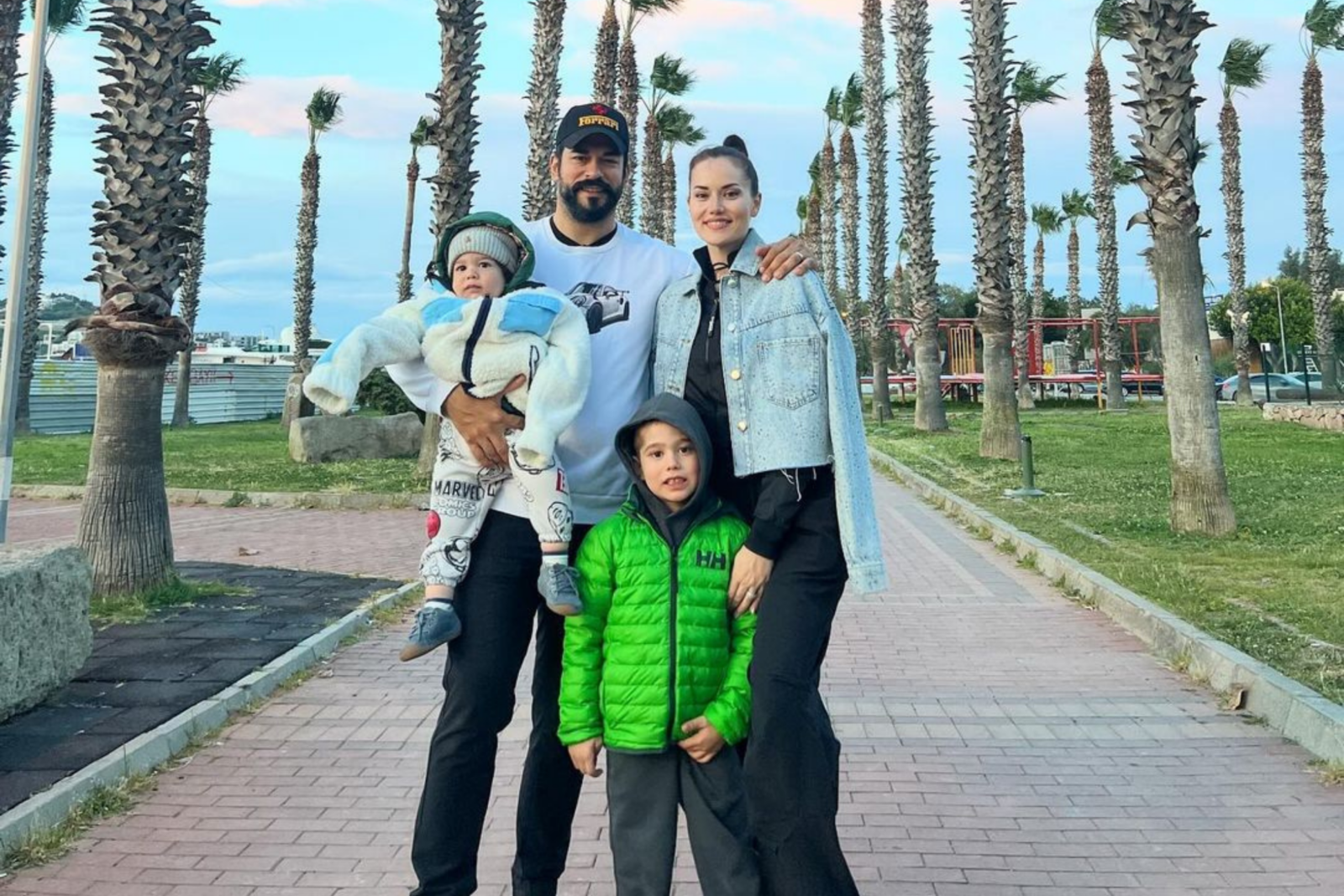 Burak Ozcivit, Fahriye Evcen and their kids pose during a family day out