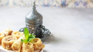 Baklava or baklawa. Ramadan Dessert. Traditional Arabic dessert with pistachios, honey and mint tea on dark surface, selective focus.