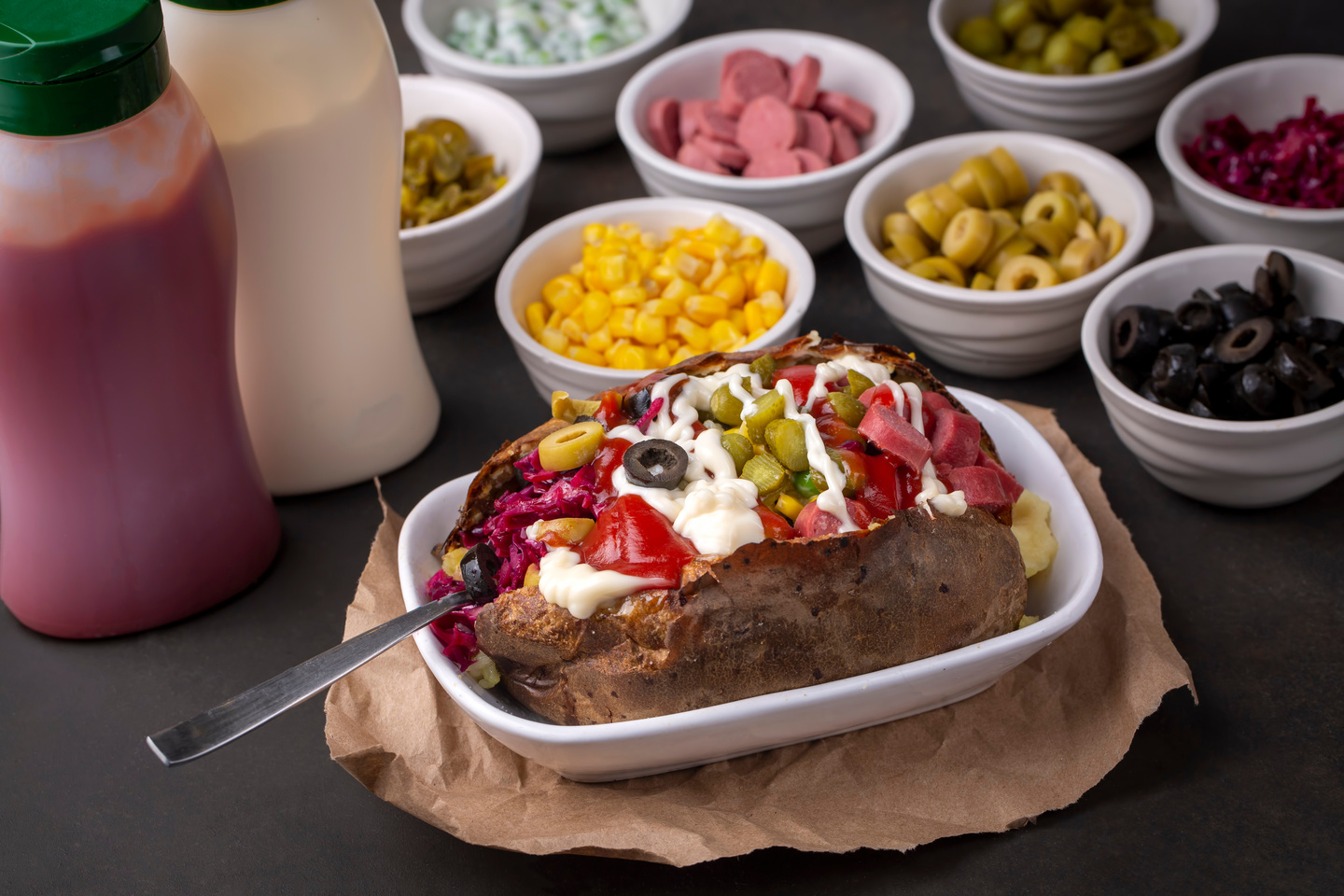 Kumpir, Turkish baked potato with cheese, corn, sausage, ketchup, mayonnaise and olives. This kumpir is traditional turkish food